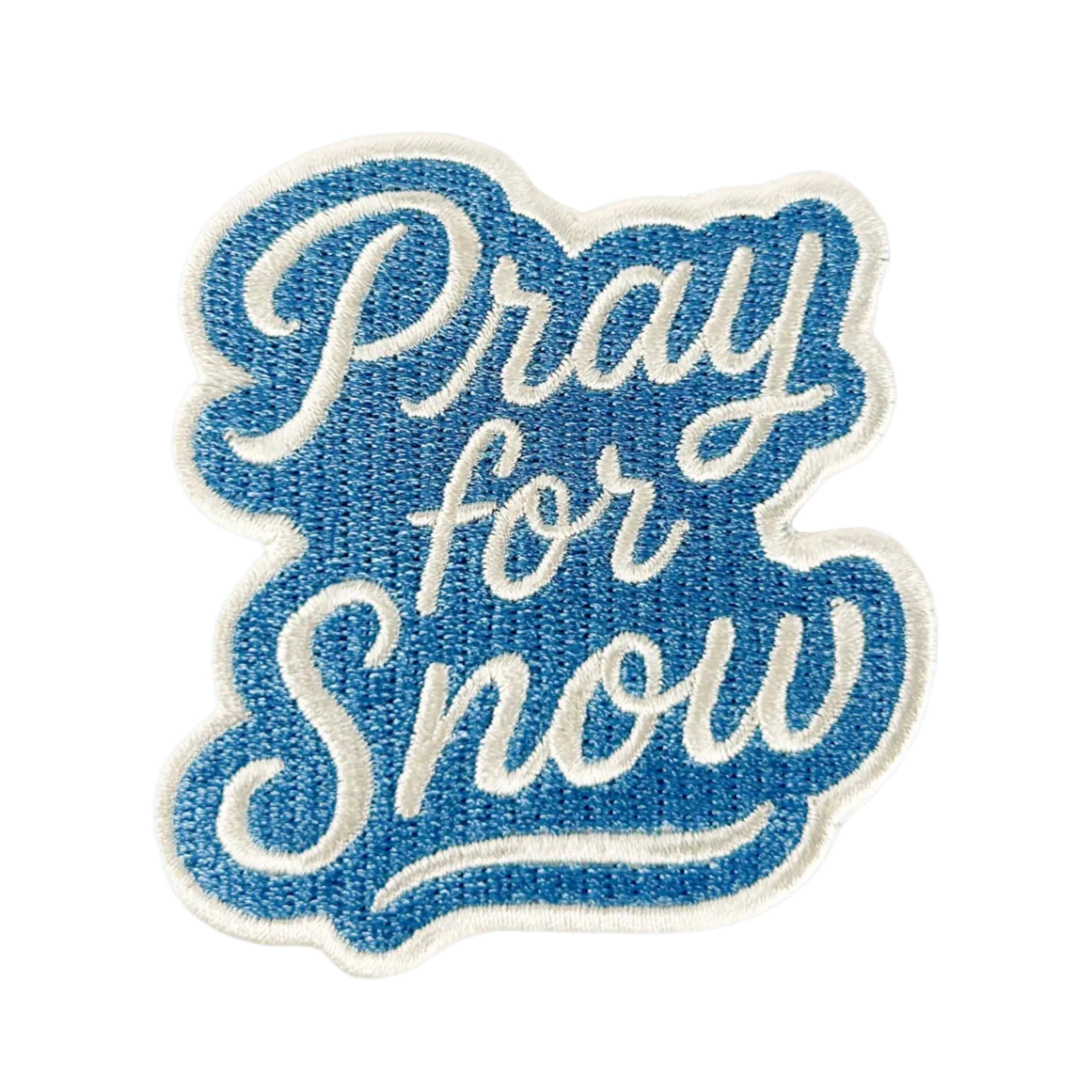 Embroidered patch with 'Pray for Snow' text on a white background